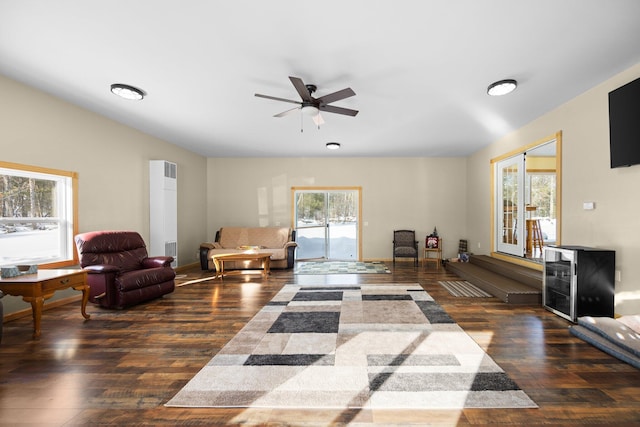 living area with a ceiling fan and wood finished floors