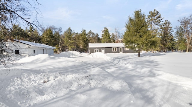 yard layered in snow with a garage