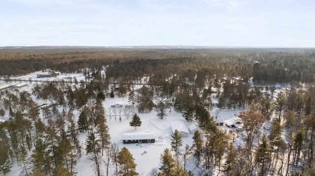 snowy aerial view featuring a view of trees