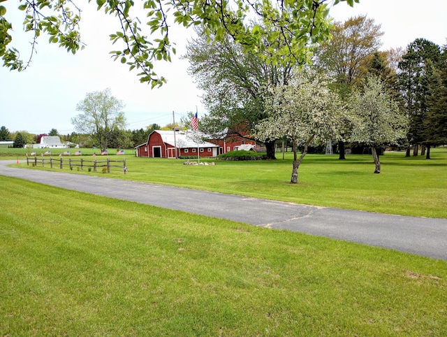 8110 Perry Rd, Houghton Lake, MI 48629 - view of property's community featuring a barn, a yard, and an outbuilding