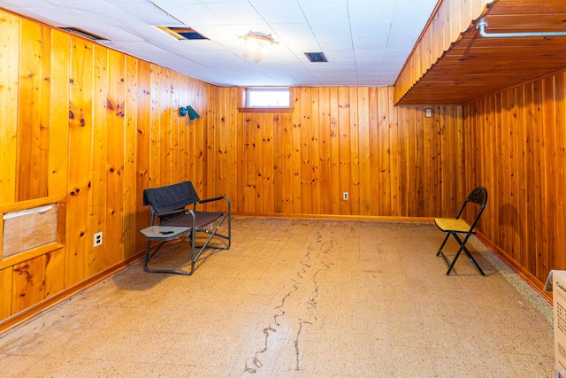 208 Stuckey Ave, Roscommon, MI 48653 - unfurnished room with tile patterned floors, wood walls, baseboards, and visible vents