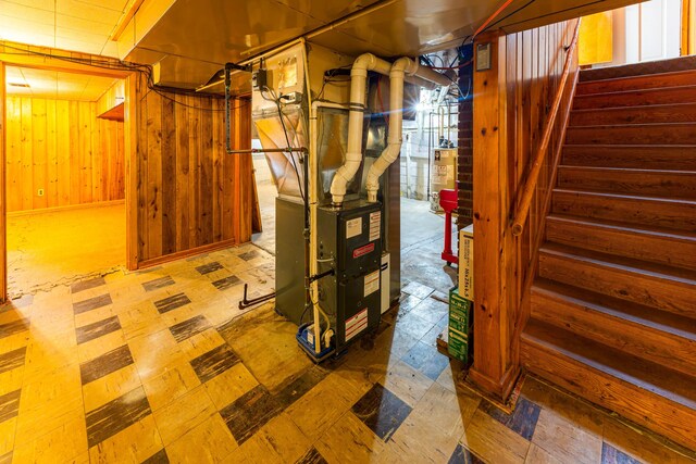 208 Stuckey Ave, Roscommon, MI 48653 - finished basement with water heater, wood walls, stairway, and tile patterned floors