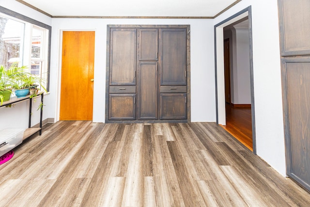 208 Stuckey Ave, Roscommon, MI 48653 - unfurnished bedroom featuring ornamental molding and wood finished floors