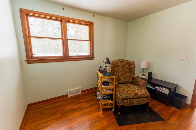 208 Stuckey Ave, Roscommon, MI 48653 - living area featuring hardwood / wood-style floors, baseboards, and visible vents