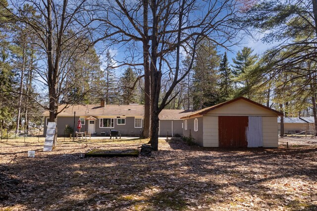 208 Stuckey Ave, Roscommon, MI 48653 - view of yard featuring a garage and a patio area