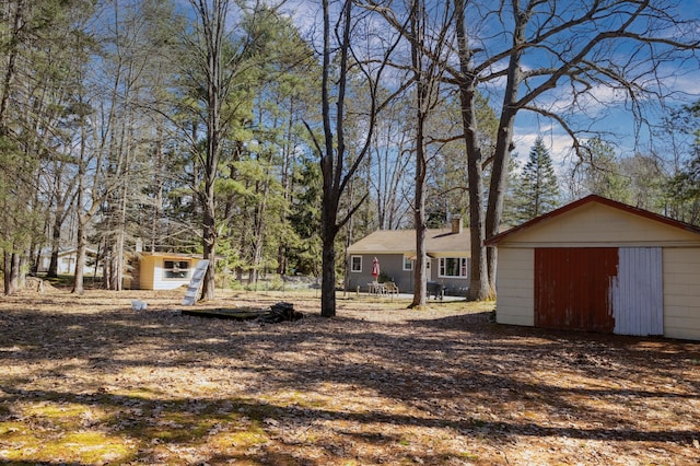 208 Stuckey Ave, Roscommon, MI 48653 - view of yard with an outdoor structure and a garage