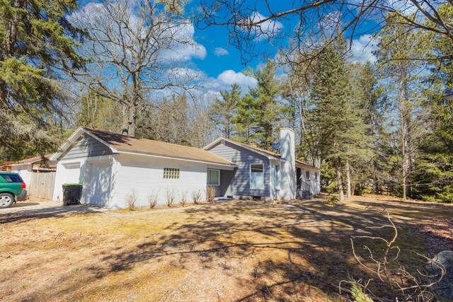 208 Stuckey Ave, Roscommon, MI 48653 - view of side of home with a garage and fence
