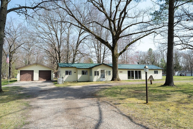 3222 E Houghton Lake Dr, Houghton Lake, MI 48629 - ranch-style house with a detached garage, an outdoor structure, metal roof, a front lawn, and central air condition unit