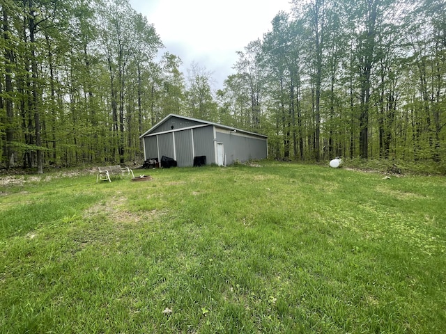 8598 N Sherman Rd, Frederic, MI 49733 - view of yard featuring an outbuilding and an outdoor structure
