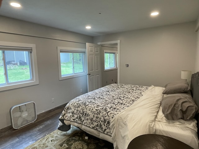8598 N Sherman Rd, Frederic, MI 49733 - bedroom with multiple windows, dark wood-style floors, recessed lighting, and baseboards
