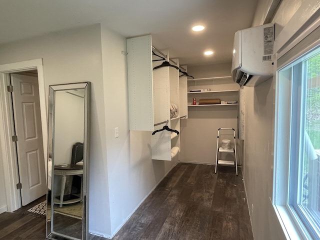 8598 N Sherman Rd, Frederic, MI 49733 - walk in closet featuring dark wood-style floors and an AC wall unit