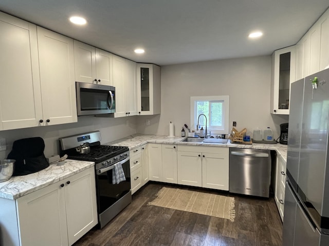8598 N Sherman Rd, Frederic, MI 49733 - kitchen featuring appliances with stainless steel finishes, a sink, dark wood finished floors, white cabinetry, and recessed lighting