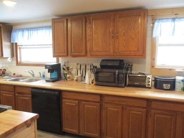 6876 Old Alba Rd, Gaylord, MI 49735 - kitchen featuring tasteful backsplash, brown cabinets, dishwasher, a sink, and stainless steel microwave