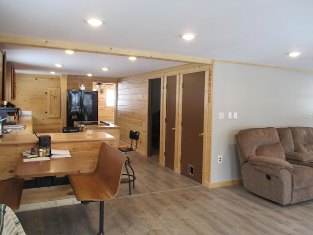 6876 Old Alba Rd, Gaylord, MI 49735 - living room with recessed lighting, baseboards, wood walls, and light wood finished floors