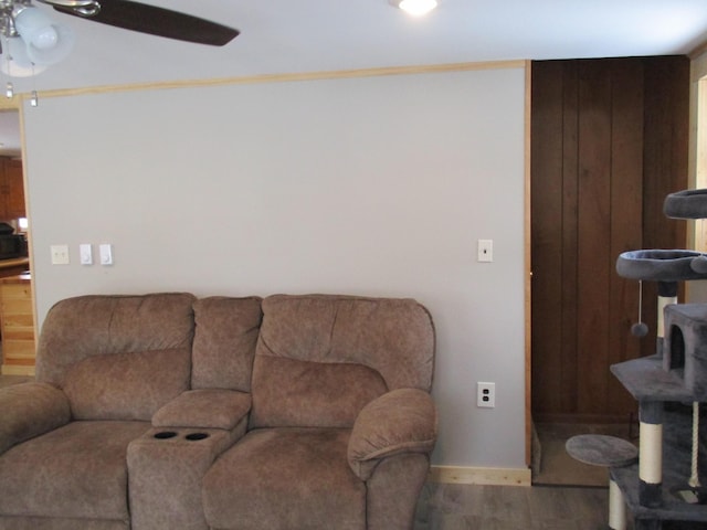 6876 Old Alba Rd, Gaylord, MI 49735 - living room featuring baseboards, ornamental molding, ceiling fan, and wood finished floors