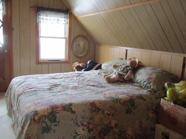 6876 Old Alba Rd, Gaylord, MI 49735 - bedroom with wooden walls, vaulted ceiling, carpet floors, and wooden ceiling