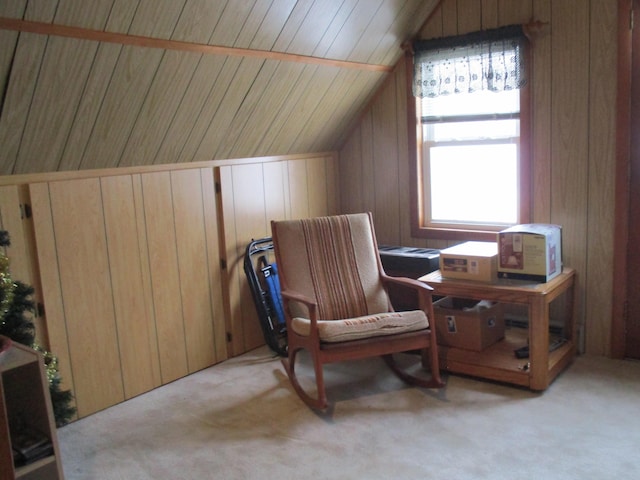 6876 Old Alba Rd, Gaylord, MI 49735 - living area featuring light colored carpet, wood walls, and vaulted ceiling