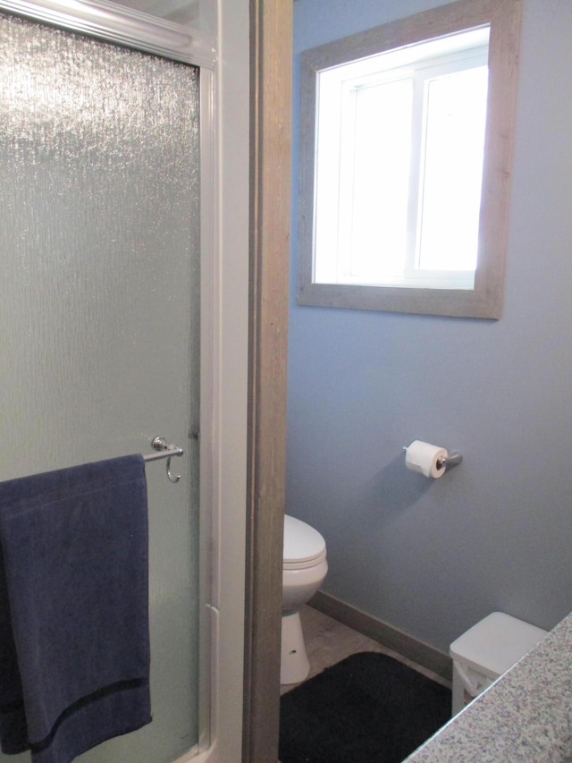 6876 Old Alba Rd, Gaylord, MI 49735 - bathroom with baseboards, a shower stall, and toilet