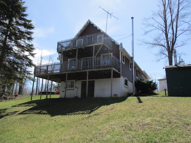 6876 Old Alba Rd, Gaylord, MI 49735 - rear view of house featuring a lawn and a wooden deck