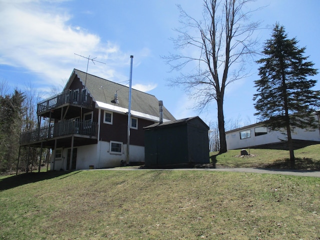 6876 Old Alba Rd, Gaylord, MI 49735 - rear view of house featuring a lawn and a wooden deck