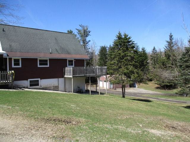 6876 Old Alba Rd, Gaylord, MI 49735 - rear view of property featuring an outdoor structure, a yard, and a deck