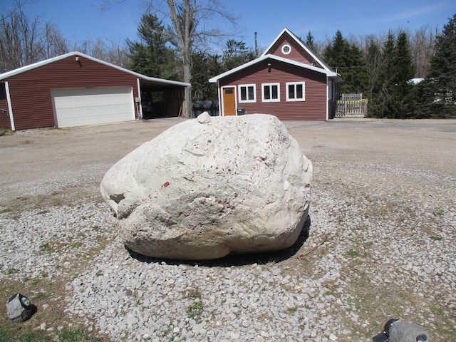 6876 Old Alba Rd, Gaylord, MI 49735 - exterior space featuring an outdoor structure and a garage