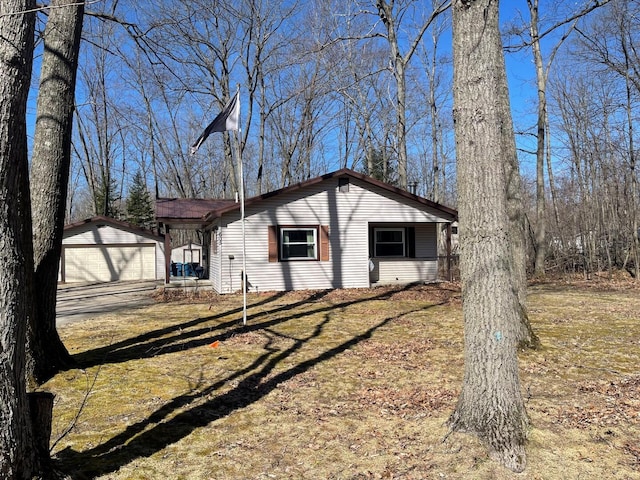 view of home's exterior featuring an outbuilding and a detached garage