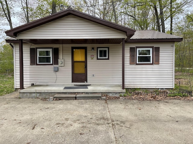 605 Englewood Dr, Roscommon, MI 48653 - bungalow-style home with covered porch and metal roof