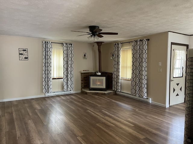 605 Englewood Dr, Roscommon, MI 48653 - unfurnished living room with baseboard heating, healthy amount of natural light, ceiling fan, a textured ceiling, and wood finished floors