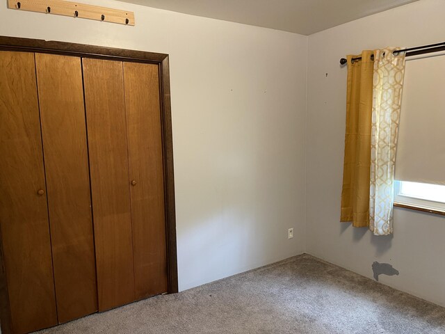 605 Englewood Dr, Roscommon, MI 48653 - unfurnished bedroom with carpet floors and a closet