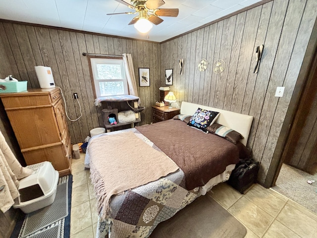 tiled bedroom with a ceiling fan and crown molding