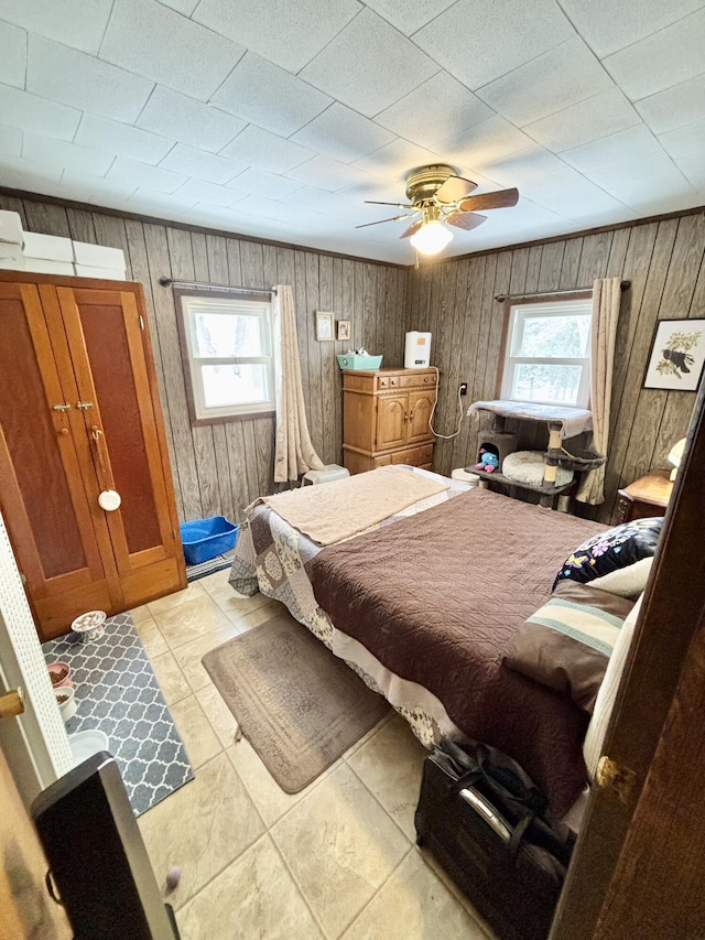 bedroom featuring multiple windows, crown molding, and ceiling fan