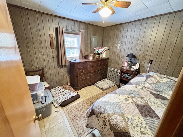 bedroom with light tile patterned floors, wood walls, and a ceiling fan