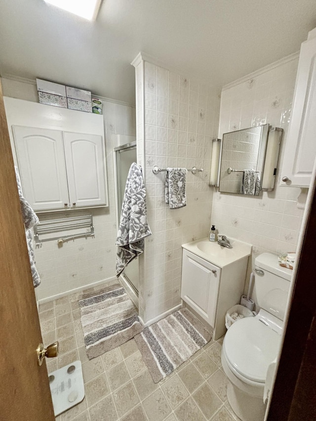 bathroom featuring vanity, tile walls, toilet, and a stall shower