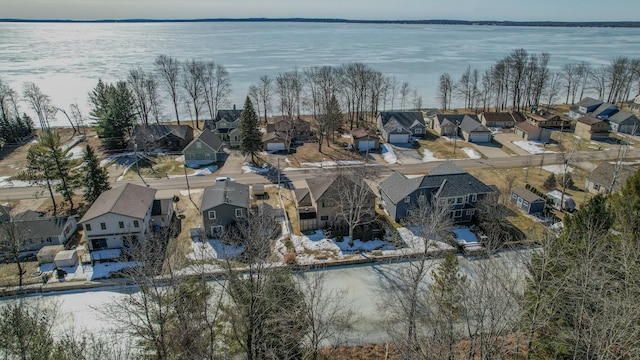 drone / aerial view with a residential view and a water view