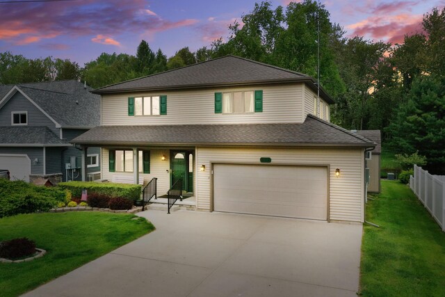 944 Long Point Dr, Houghton Lake, MI 48629 - view of front of home with concrete driveway, an attached garage, a shingled roof, and covered porch