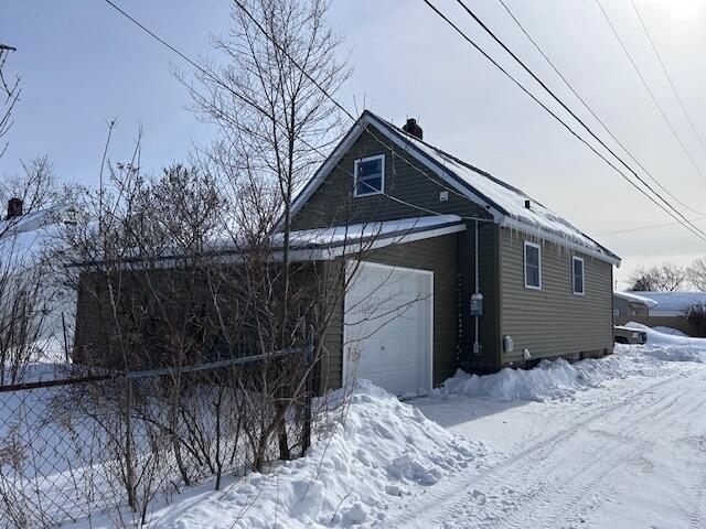 exterior space with a detached garage