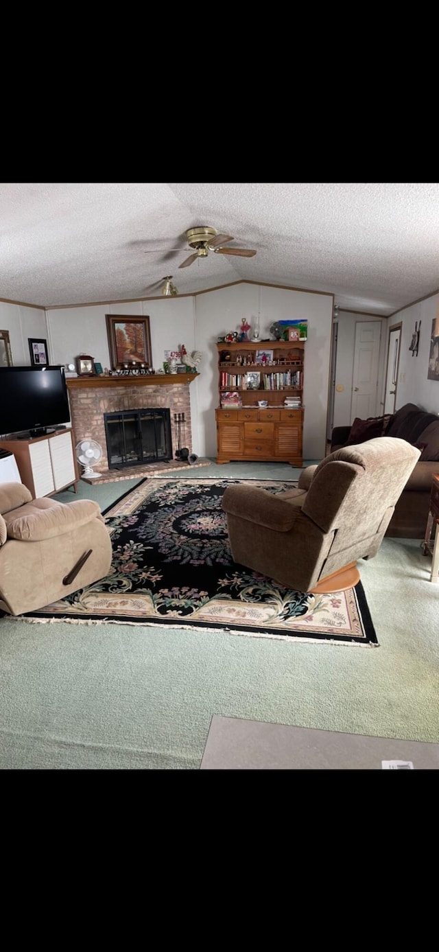 living room featuring carpet flooring, a brick fireplace, a textured ceiling, and vaulted ceiling