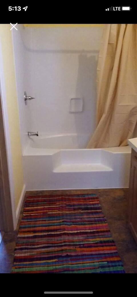 bathroom with vanity and shower / tub combo