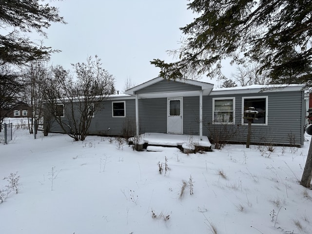 snow covered property featuring a garage