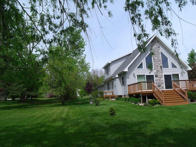15117 Valley Dr, Wolverine, MI 49799 - rear view of house featuring a deck, a yard, and stairway