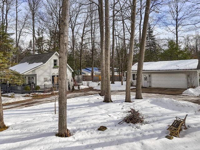 yard layered in snow featuring a garage