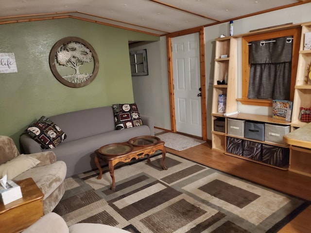 living area featuring lofted ceiling and wood finished floors