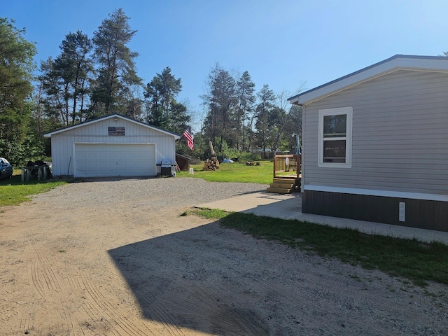 view of yard with a garage and an outdoor structure