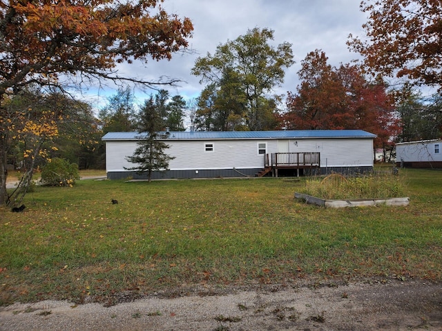 exterior space with a wooden deck and a front yard