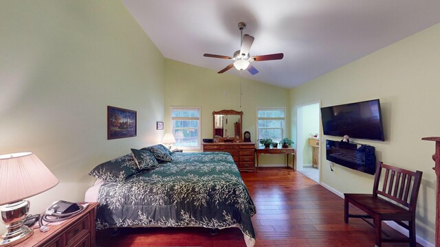 bedroom with baseboards, lofted ceiling, dark wood-type flooring, and ceiling fan