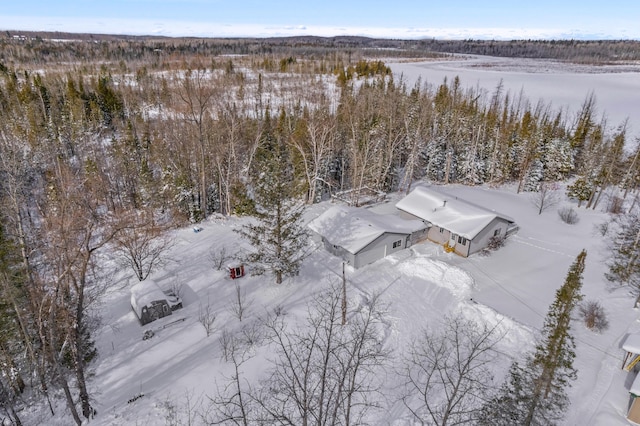 snowy aerial view with a view of trees