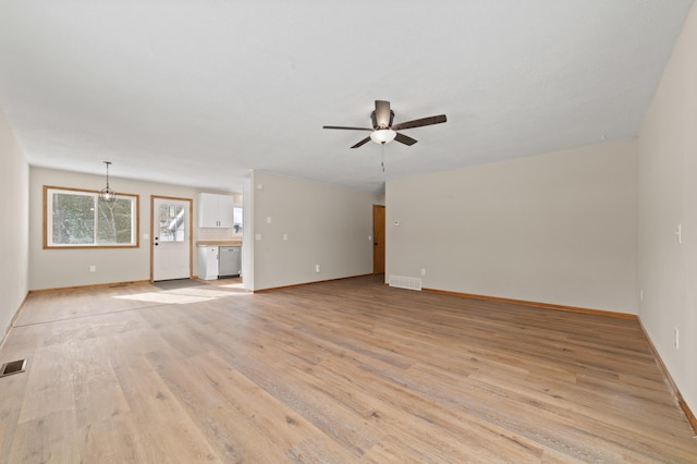 unfurnished living room with a ceiling fan, light wood-style floors, visible vents, and baseboards