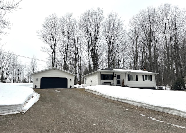 view of front of property with a garage and an outdoor structure