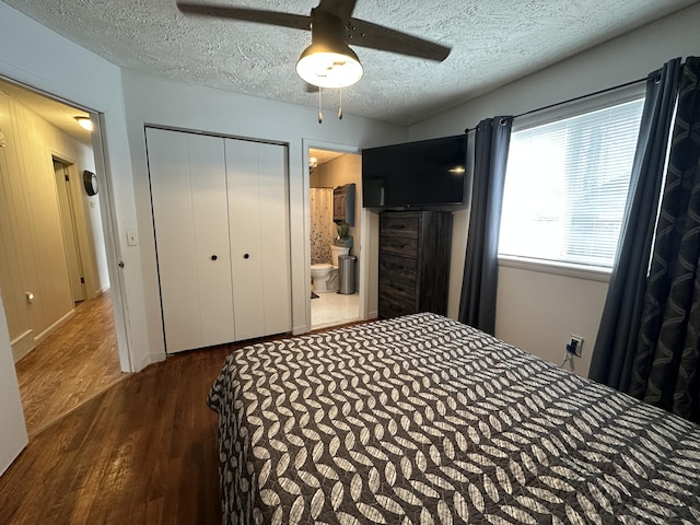 bedroom with ceiling fan, ensuite bath, wood finished floors, a closet, and a textured ceiling